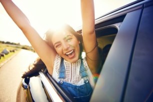 Exuberant young woman celebrating her vacation