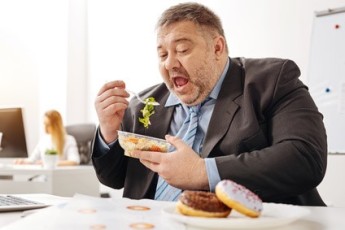 Comical chubby guy not sticking to his diet