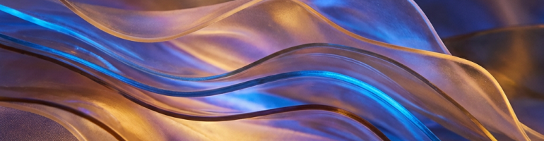 Abstract translucent waves glowing with amber and blue light on a black background.